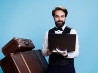 Doorkeeper holding modern laptop