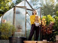 Woman with jugs in garden