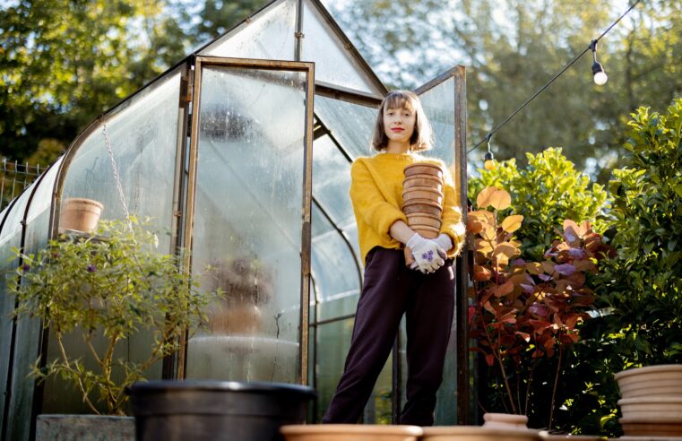 Woman with jugs in garden